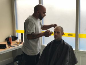 Nick_ barber volunteer at the 999 Club with a client